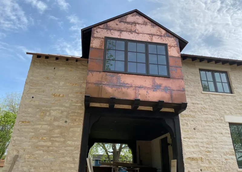 Copper metal panel facade on a stone building for Skylight Installation in Wahpeton